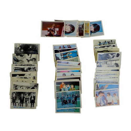 208 - A collection of world stamps and trade cards, including the Beatles, in two folders.(2)