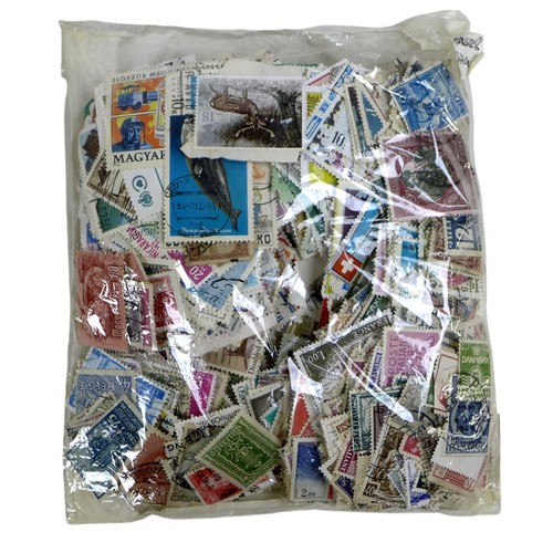 208 - A collection of world stamps and trade cards, including the Beatles, in two folders.(2)