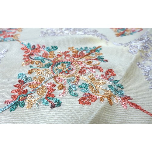 210 - An embroidered wool shawl, 225 by 104cm.