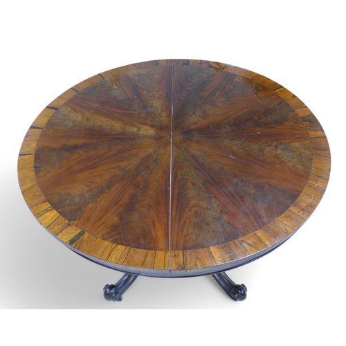 309 - A 19th century rosewood breakfast table, with a segmented top on a quatrefoil scroll base, 117cm dia... 