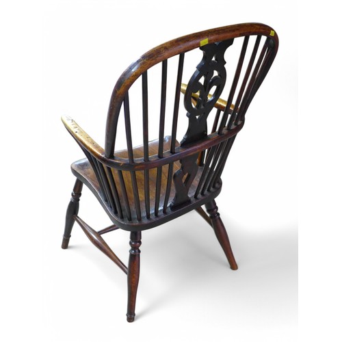 324 - A 19th century ash and elm stick back Windsor elbow chair, with a fleur de lys splat, 47 by 56 by 96... 