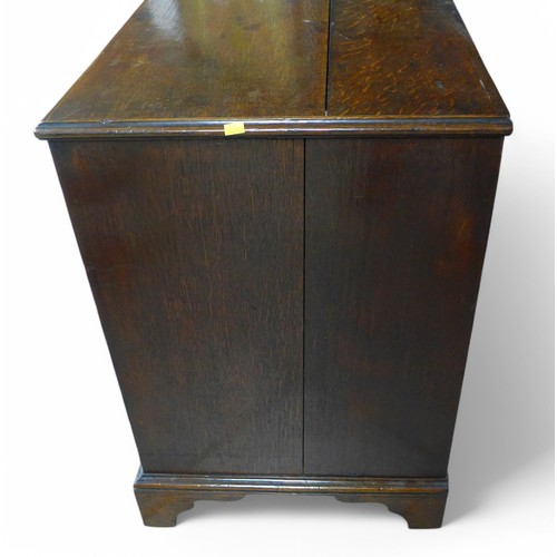 310 - A George III oak four drawer chest on shaped bracket feet, 89 by 49 by 74cm high.