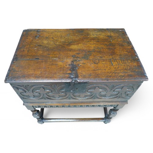 302 - An 18th century carved oak bible box on later stand, 87 by 42 by 73cm high.