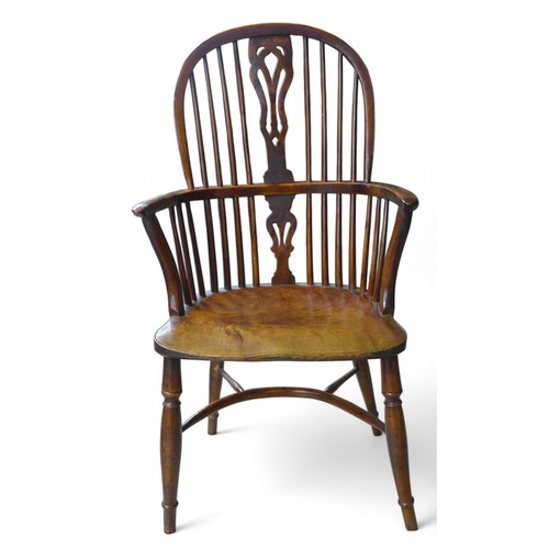 326 - A 19th century yew wood and elm stick back Windsor armchair, with a shaped splat on turned legs unit... 