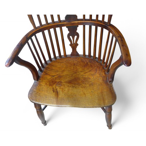 326 - A 19th century yew wood and elm stick back Windsor armchair, with a shaped splat on turned legs unit... 