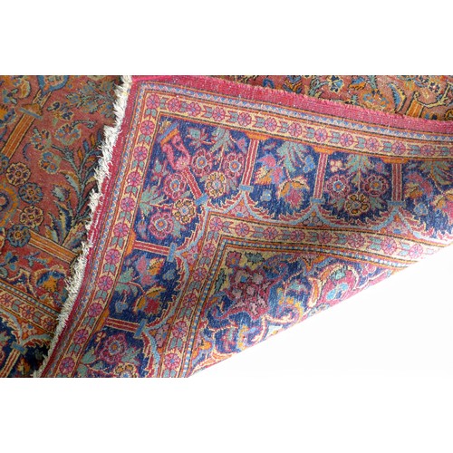 332 - A pair of hand knotted woolen Kashan Persian rugs, with a central medallion on a red field and styli... 