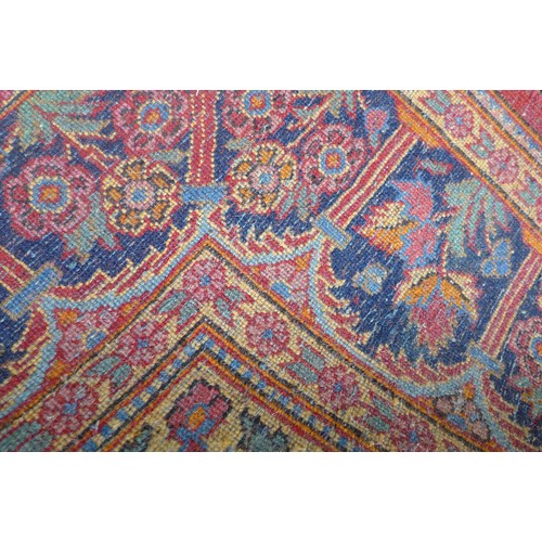 332 - A pair of hand knotted woolen Kashan Persian rugs, with a central medallion on a red field and styli... 