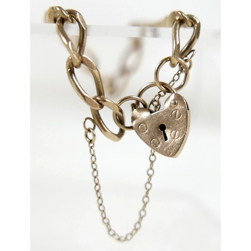 44 - A 9ct yellow gold kerb link bracelet, with heart shaped padlock clasp and attached safety chain, 5.5... 