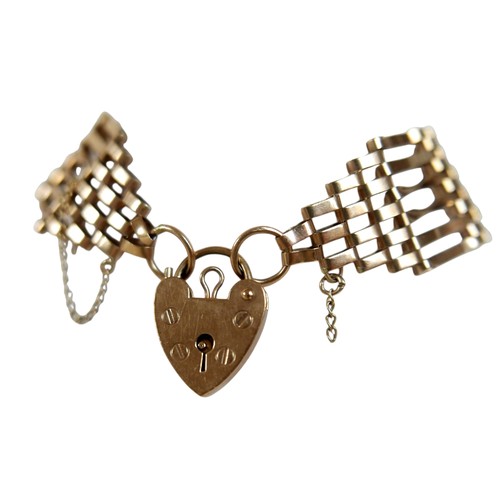 45 - A 9ct yellow gold gate link bracelet, with heart shaped padlock clasp and attached safety chain, 20m... 