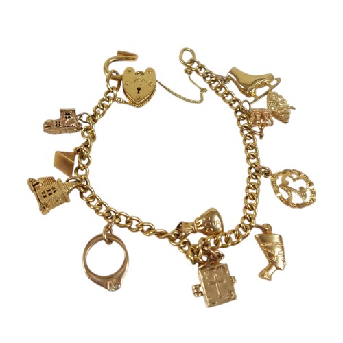 53 - A 9ct yellow gold kerb link charm bracelet, fitted with twelve 9ct gold / unmarked charms, including... 