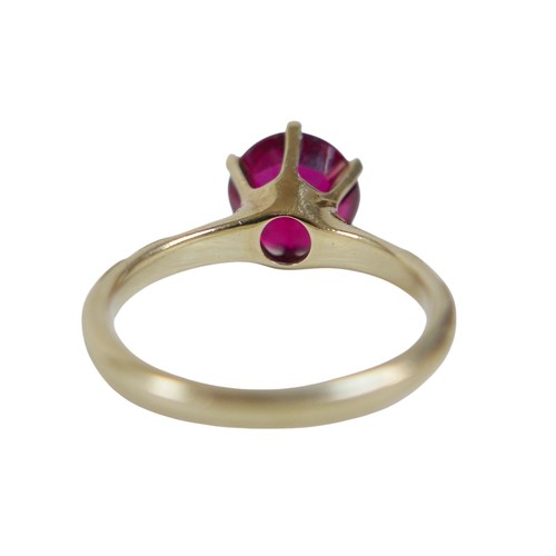 42 - A 14k yellow gold dress ring, set with a solitaire round faceted cut red stone, 9 by 6mm, in six cla... 