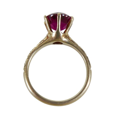 42 - A 14k yellow gold dress ring, set with a solitaire round faceted cut red stone, 9 by 6mm, in six cla... 