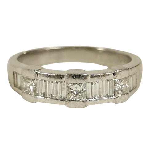 108 - A platinum and diamond ring, set with a row of three princess cut stones, each 3 by 3mm, separated b... 