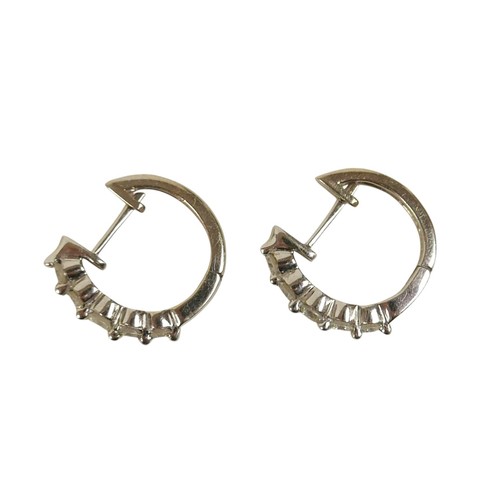 84 - A pair of 14k white gold and diamond set clip earrings, each set with a row of five graduating round... 