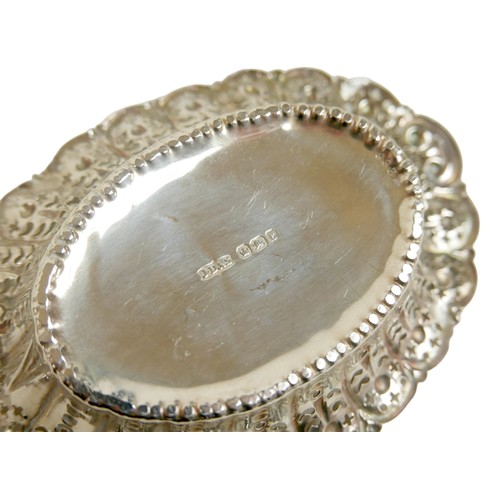 23 - A small group of silver, including small dishes, napkin rings, and a decorative needle case, total c... 