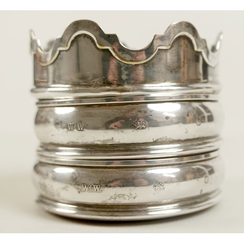 9 - A pair of Elizabeth II silver wine bottle coasters, with plain rims and sides, with turned wooden an... 