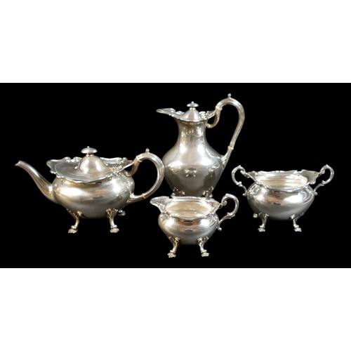 2 - A Scottish Edward VII silver four piece tea service, decorated with shaped upper rims and raised on ... 