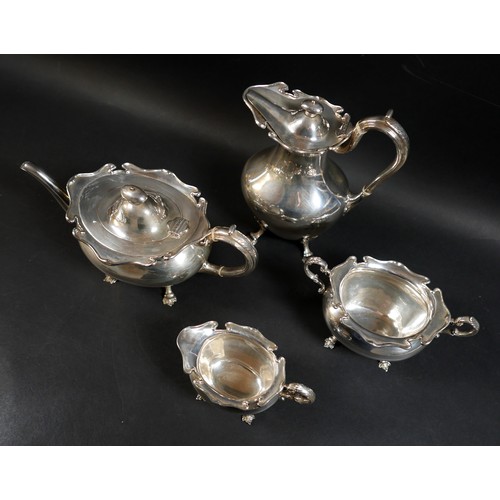 2 - A Scottish Edward VII silver four piece tea service, decorated with shaped upper rims and raised on ... 