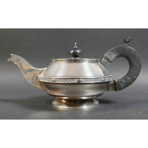 29 - A George V silver three piece tea service, of compressed ovoid form on a circular foot, with a decor... 