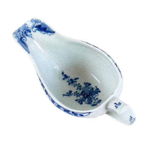 137 - An 18th century Lowestoft porcelain small sauce boat, decorated with moulded exterior and in undergl... 