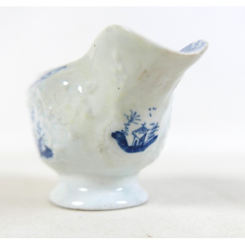 137 - An 18th century Lowestoft porcelain small sauce boat, decorated with moulded exterior and in undergl... 