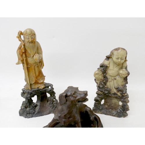 124 - A carved Chinese soapstone figure of Guanyin holding a peach on rocky base, 25cm, a carved soapstone... 