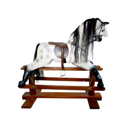 226 - A piebald wooden rocking horse by Horseplay with leather saddle and tack, 127 by 45 by 120cm high.