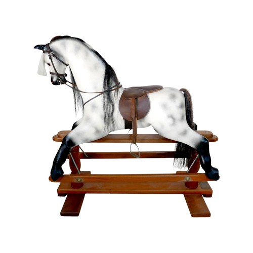 226 - A piebald wooden rocking horse by Horseplay with leather saddle and tack, 127 by 45 by 120cm high.