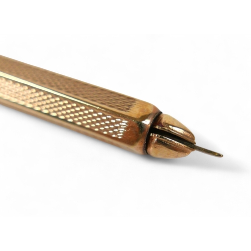 24 - A 9ct yellow gold toothpick, with sprung release, loop attachment, and engine turned decoration, C&S... 