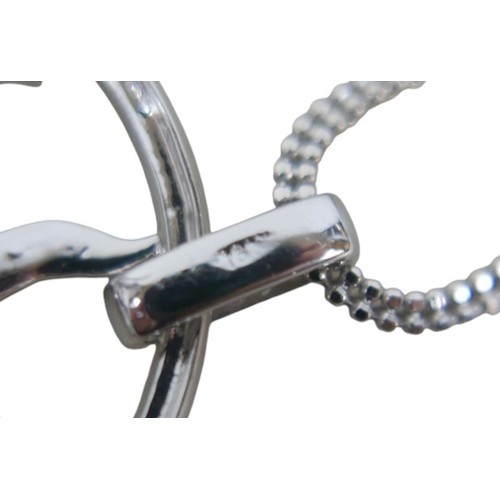 14 - An 18ct white gold diamond sunburst design pendant, encrusted with diamonds with three loose stones ... 