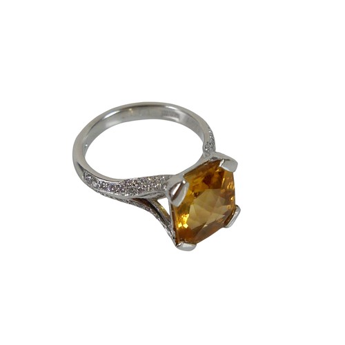 12 - An 18ct white gold citrine and diamond ring, the radiant cut stone approximately 9 by 12mm, with sma... 