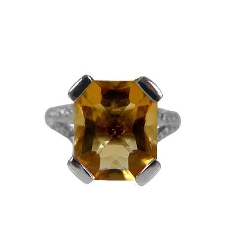 12 - An 18ct white gold citrine and diamond ring, the radiant cut stone approximately 9 by 12mm, with sma... 
