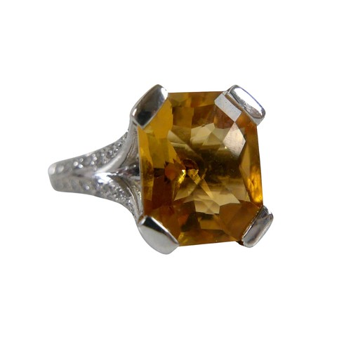 12 - An 18ct white gold citrine and diamond ring, the radiant cut stone approximately 9 by 12mm, with sma... 