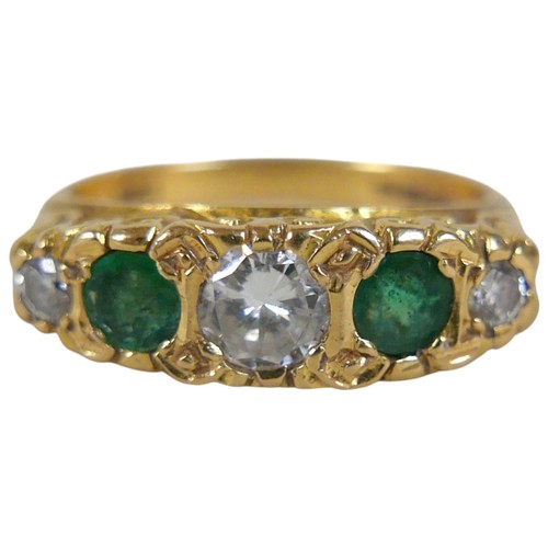 5 - An 18ct yellow gold five stone emerald and diamond ring the central diamond approximately 0.25ct, ri... 