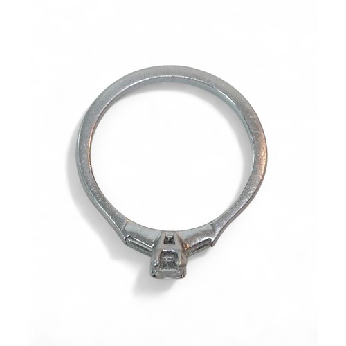 59 - A three stone diamond and platinum ring, the radiant cut central stone 4.5 by 3.5mm, flanked by sing... 