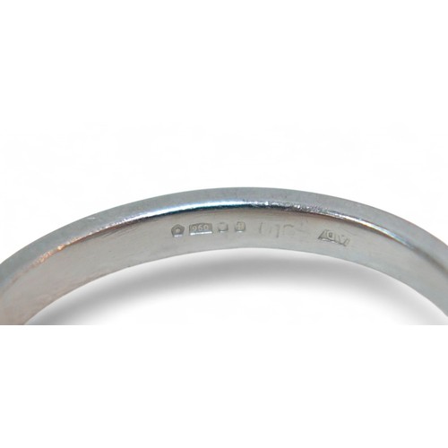 59 - A three stone diamond and platinum ring, the radiant cut central stone 4.5 by 3.5mm, flanked by sing... 