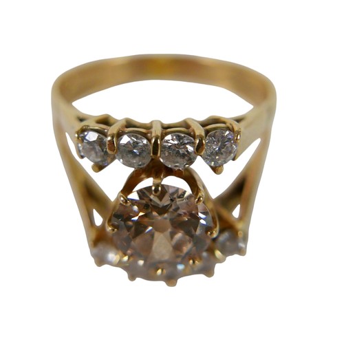 2 - A ten stone diamond 18ct gold ring, the large central stone, 7.3mm diameter, approximately 1.5ct, wi... 