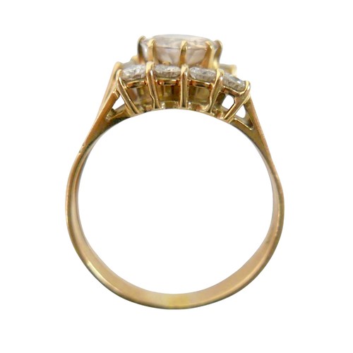 2 - A ten stone diamond 18ct gold ring, the large central stone, 7.3mm diameter, approximately 1.5ct, wi... 