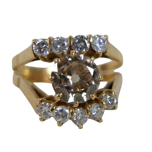 2 - A ten stone diamond 18ct gold ring, the large central stone, 7.3mm diameter, approximately 1.5ct, wi... 