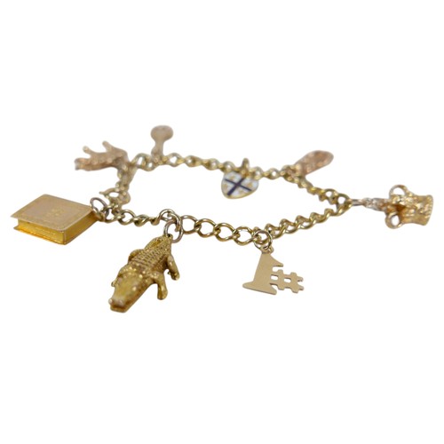 16 - A 9ct yellow gold charm bracelet with eight charms, 20.7g.