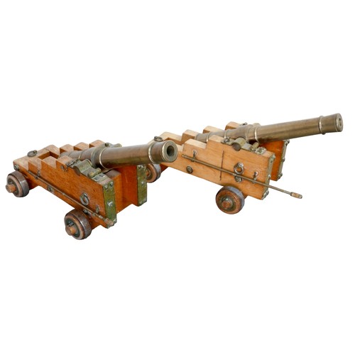 353 - A pair of engineer made 10 bore brass signal cannons on oak carriages, with tapering barrels divided... 