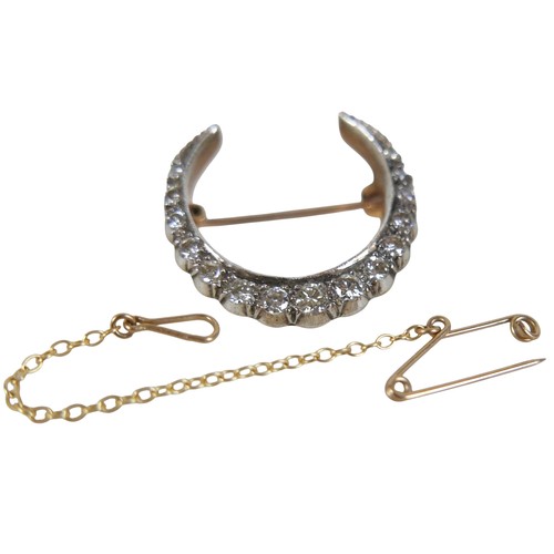 51 - A Victorian 9ct gold and diamond crescent shaped brooch, set with fifteen graduated diamonds, the la... 
