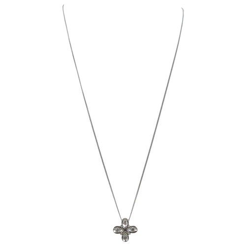 7 - A platinum and diamond pendant, the four briliant cut diamonds in a quatrefoil setting of four petal... 