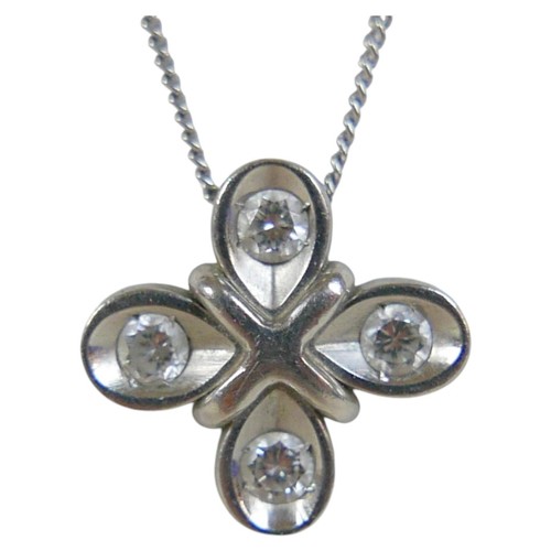 7 - A platinum and diamond pendant, the four briliant cut diamonds in a quatrefoil setting of four petal... 