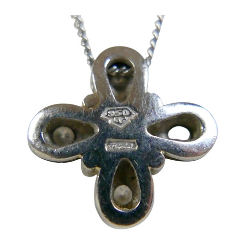 7 - A platinum and diamond pendant, the four briliant cut diamonds in a quatrefoil setting of four petal... 