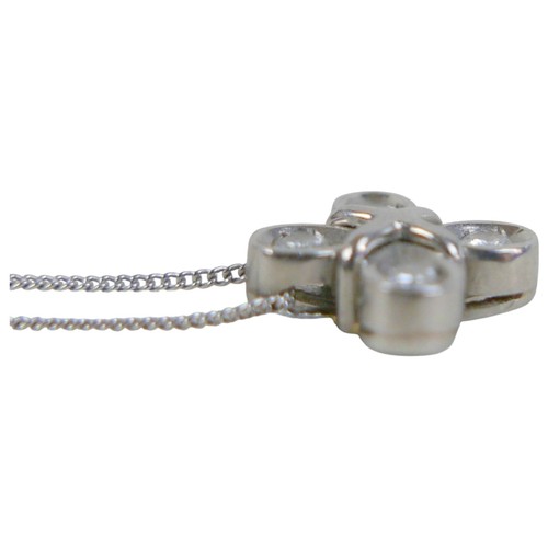 7 - A platinum and diamond pendant, the four briliant cut diamonds in a quatrefoil setting of four petal... 