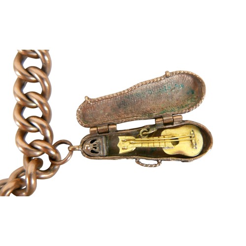 8 - A 9ct gold charm bracelet with assorted 9ct gold charms, including violin in case, double sided 19th... 
