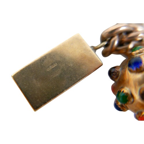 8 - A 9ct gold charm bracelet with assorted 9ct gold charms, including violin in case, double sided 19th... 