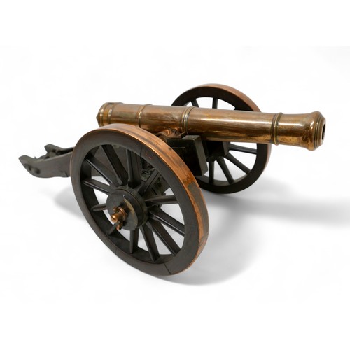 A Fine Bronze East India Company Model Of A 12-Pounder Cannon Dated 1841 Of tapering multi-stage form with raised mouldings and bell-shaped muzzle, knob-shaped cascabel-button, on original iron and copper mounted  field carriage with cambered spoked wheels, elevating screw, with East India Company heart mark below a 4, dated 1841 No1 J.M, MA 6778, barrel 44cm, total 73 by 36 by 27cm high.