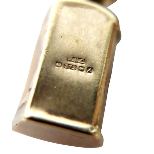 15 - A 9ct gold charm bracelet with heart lock, circular gold Taurus charm, wishbone charm, carriage with... 